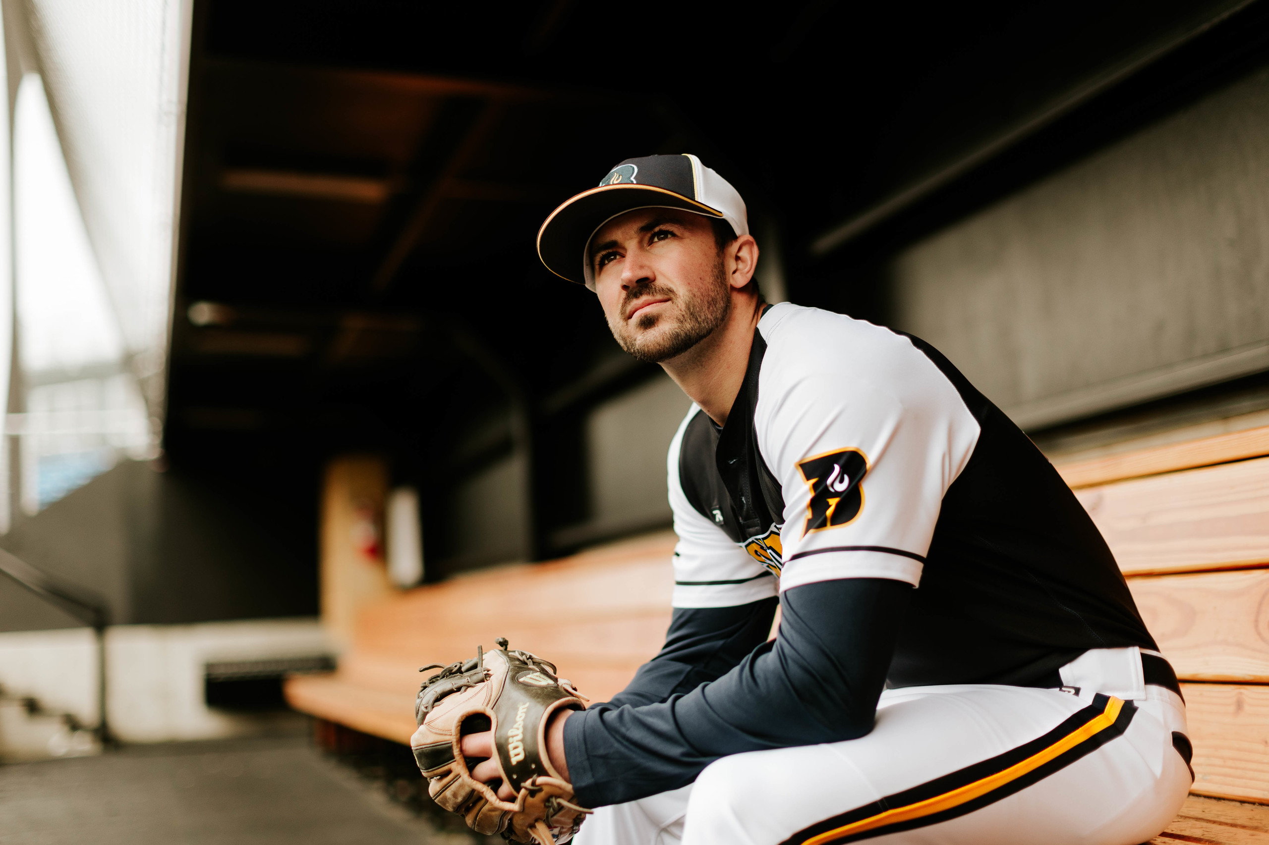 Baseball Player In Dugout Wearing Custom Richardson Hat