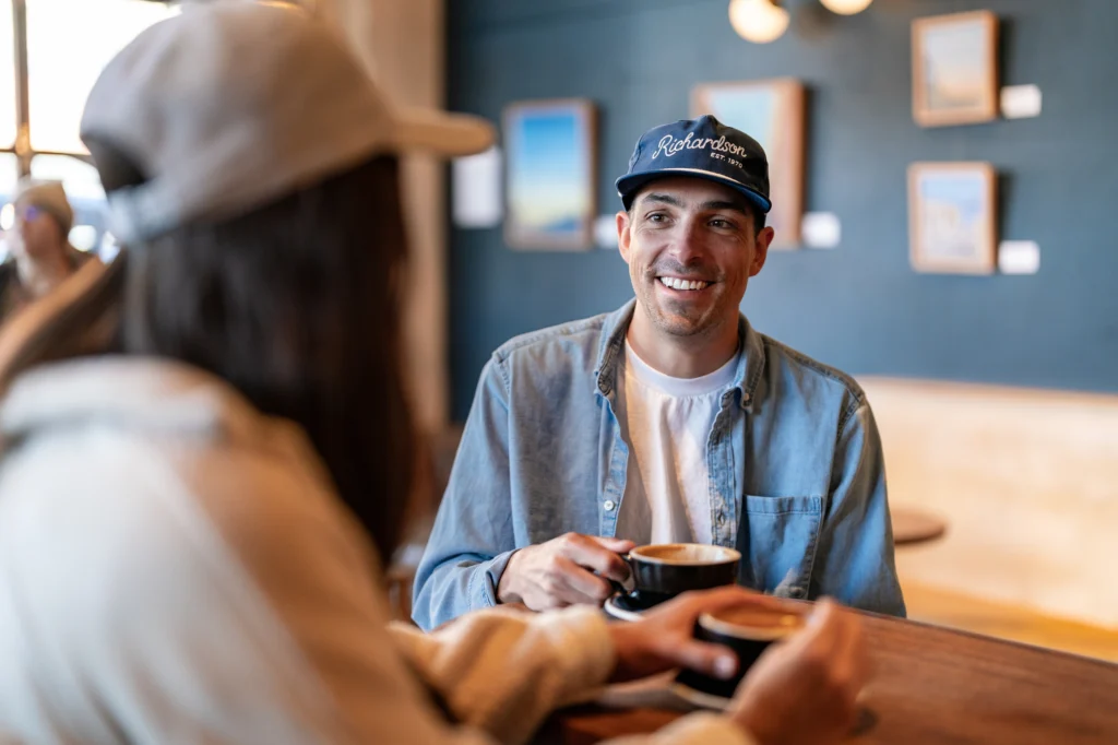 Couple Drinking Coffee Wearing Custom Richardson Hats