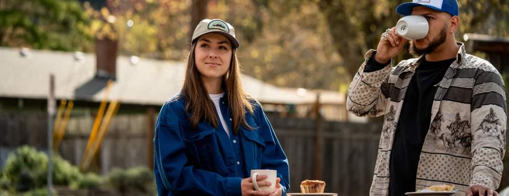 Man and Woman Drinking Coffee Outdoors Wearing Custom Richardson Hats