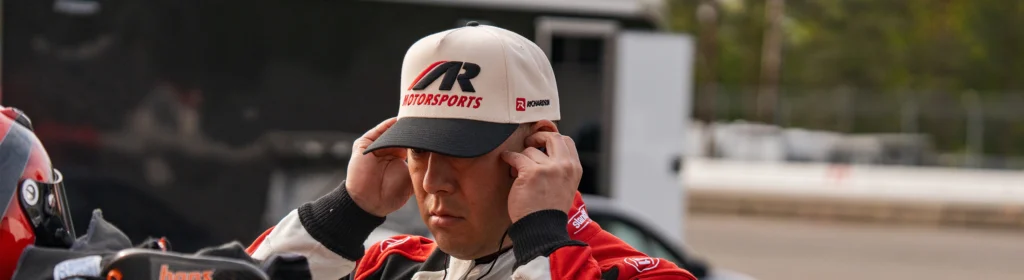 Race car driving wearing custom Richardson hat