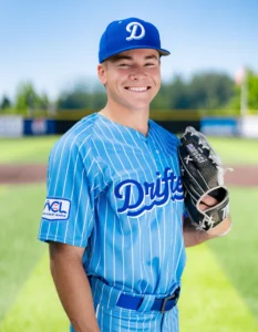 Baseball player holding mitt wearing Richardson baseball hat and uniform