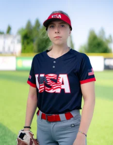 Softball player holding mitt wearing Richardson softball hat and uniform